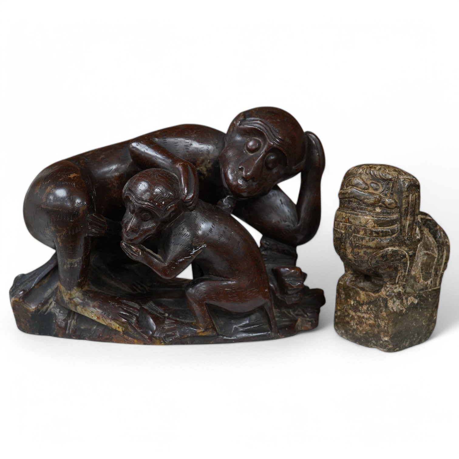 A Chinese carved soapstone ‘monkey’ group and another ‘lion dog’, monkey group 20cm x 14cm. Condition - fair to good